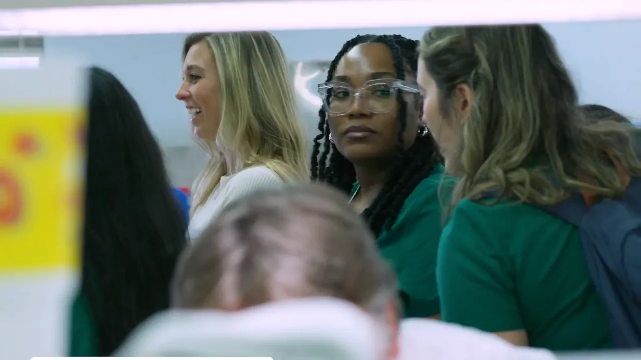 Still from the UAB School of Dentistry visit recap: students smile as they talk in the lab.